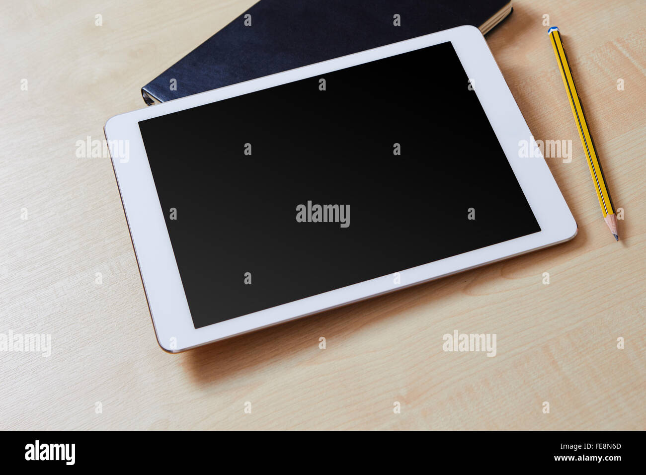 Tablet mit leeren Bildschirm auf einem Schreibtisch aus Holz und Veranstalter Stockfoto