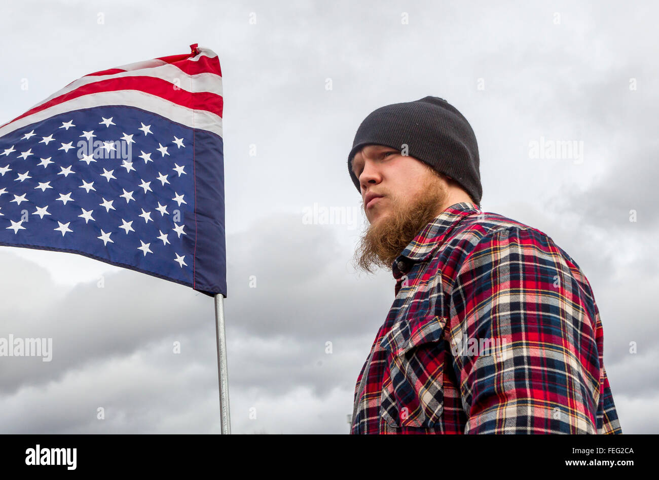 Junger Mann hält den Kopf nieder Flagge. Stockfoto