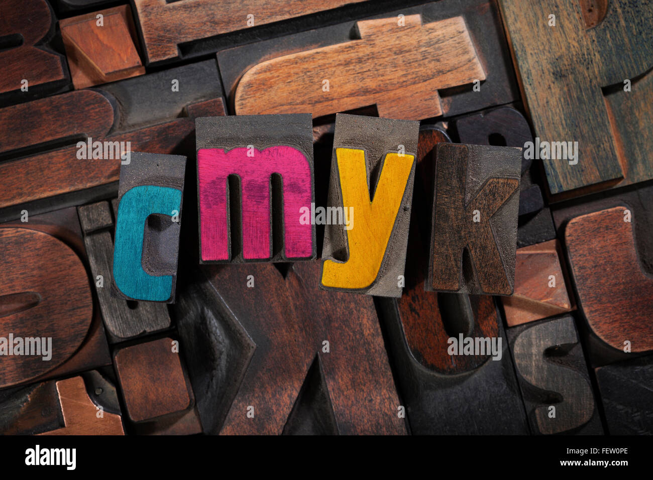 CMYK Druck Konzept - Vintage Buchdruck Druckstöcke mit Prozessfarben auf zufälligen Buchstaben Hintergrund, Ansicht von oben Stockfoto