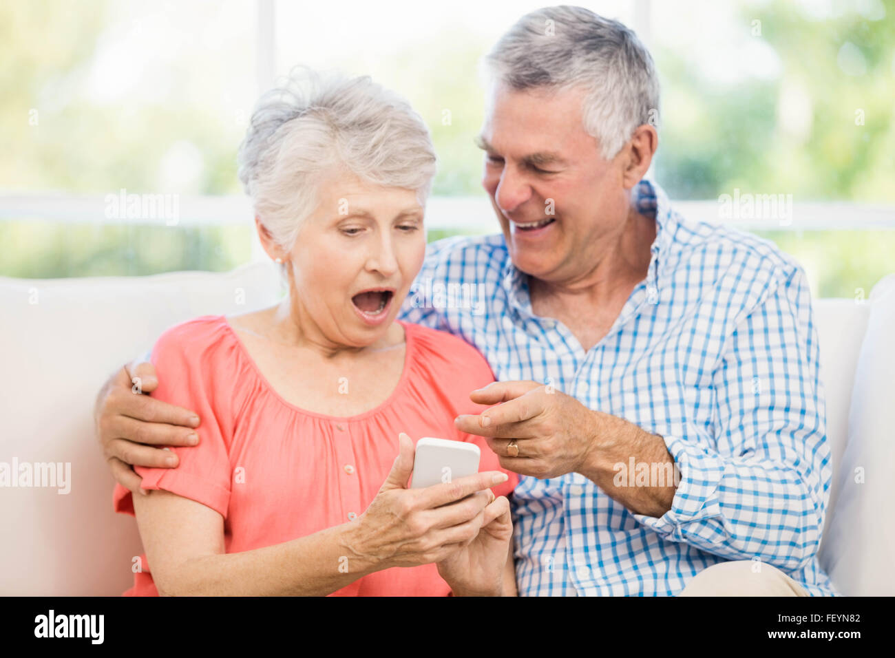 Lächelnde älteres Paar mit smartphone Stockfoto