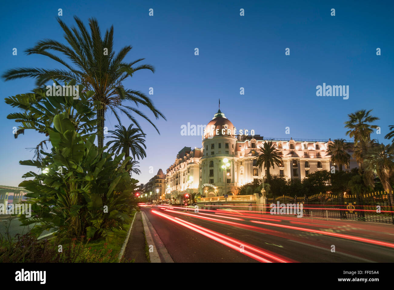 Hotel Negresco an der Promenade des Anglais in Nizza, Palmen, Verkehr, Twilight, Provence-Alpes-Cote d ' Azur, Frankreich Stockfoto