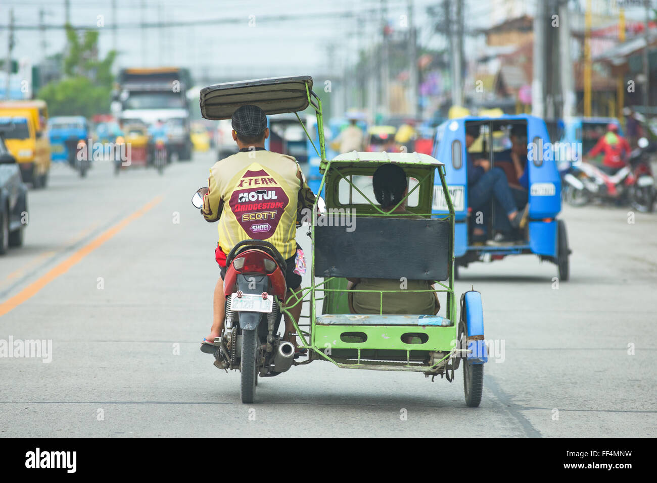 Cyclo mit Passagier in General Santos City, South Cotabato, Philippinen Stockfoto