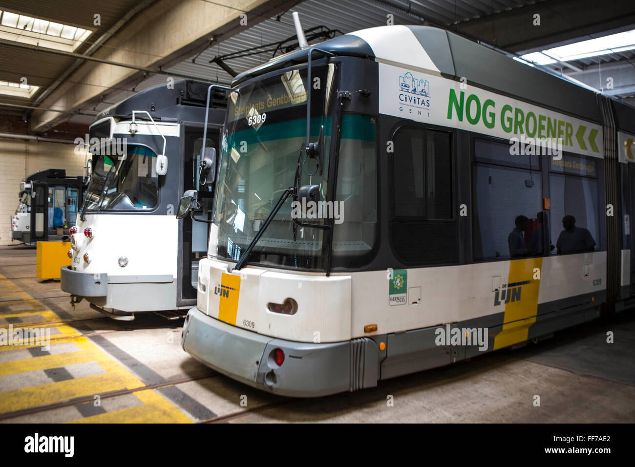 Seitlicher Blick auf eine neue De Lijn ÖPNV elektrische Straßenbahnen im Depot in Brusselsesteenweg in Gentbrugge, Gent, Belgien geparkt. Die Straßenbahnen wurden geändert und verbessert mit innovativen Energie-Management-Technologien zur Reduzierung des Energieverbrauchs.  Das Unternehmen gewann Ashden nachhaltiges Reisen eine Auszeichnung für diese Arbeit. Stockfoto