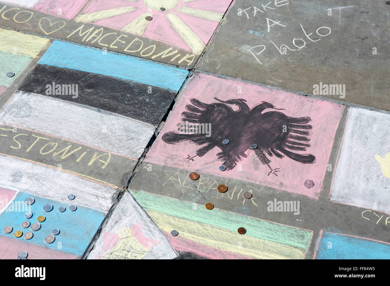 Touristen legen Sie Geld auf die Flagge ihres Heimatlandes, ein Projekt von einer Obdachlosen Gruppe um Geld zu sammeln. Trafalgar Square in London. Stockfoto