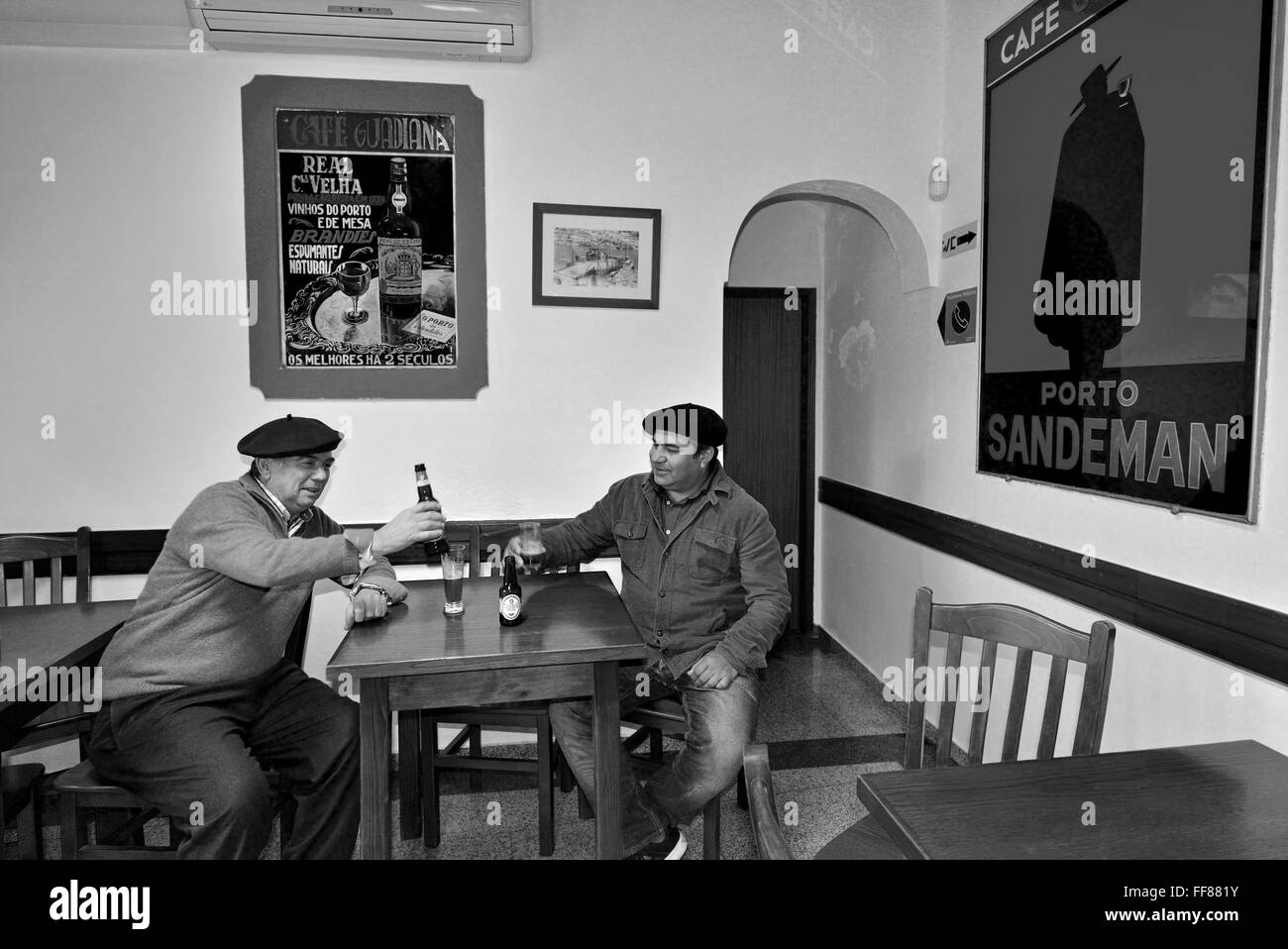 Portugal, Alentejo: Zwei einheimische Männer, die ein Bier und einen Chat in dem traditionellen Café Guadiana in Mértola (bw) Stockfoto