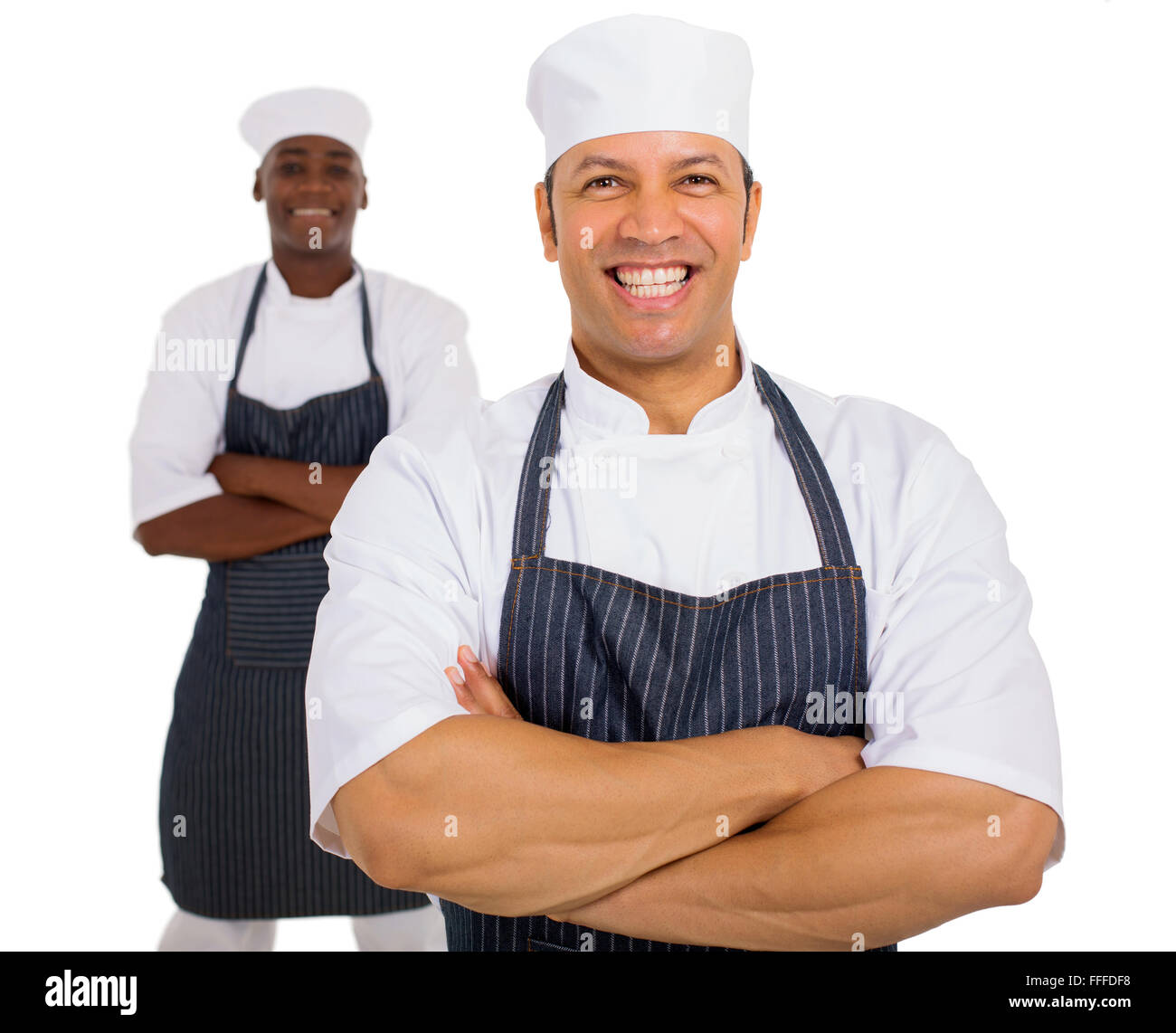 Porträt von Mitte Alter Koch mit Kollegen auf Hintergrund Stockfoto