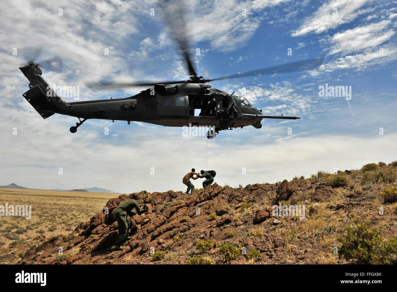 Techn. Sgt. Nicholas Brooks Dokumente als Captain Yuriza Castillo-Aguirre bereitet in einem HH-60 Pave Hawk gehisst werden. Stockfoto