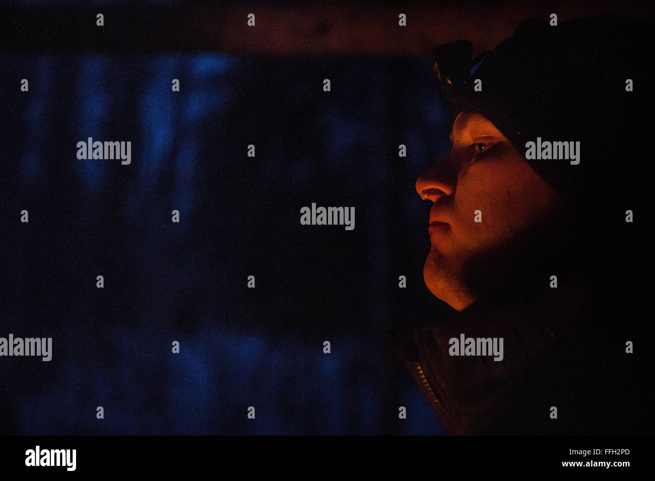 US Küstenwache Lt. Sean Groark, MH-60 Helikopterpilot, Kodiak Air Station, befindet sich in der Nähe des Feuers um warm zu bleiben, während der Arktis überleben School Eielson Air Force Base, Alaska. Das Training herausgefordert Studenten zu improvisieren und die Bedürfnisse des Überlebens bei arktischen Temperaturen. Stockfoto