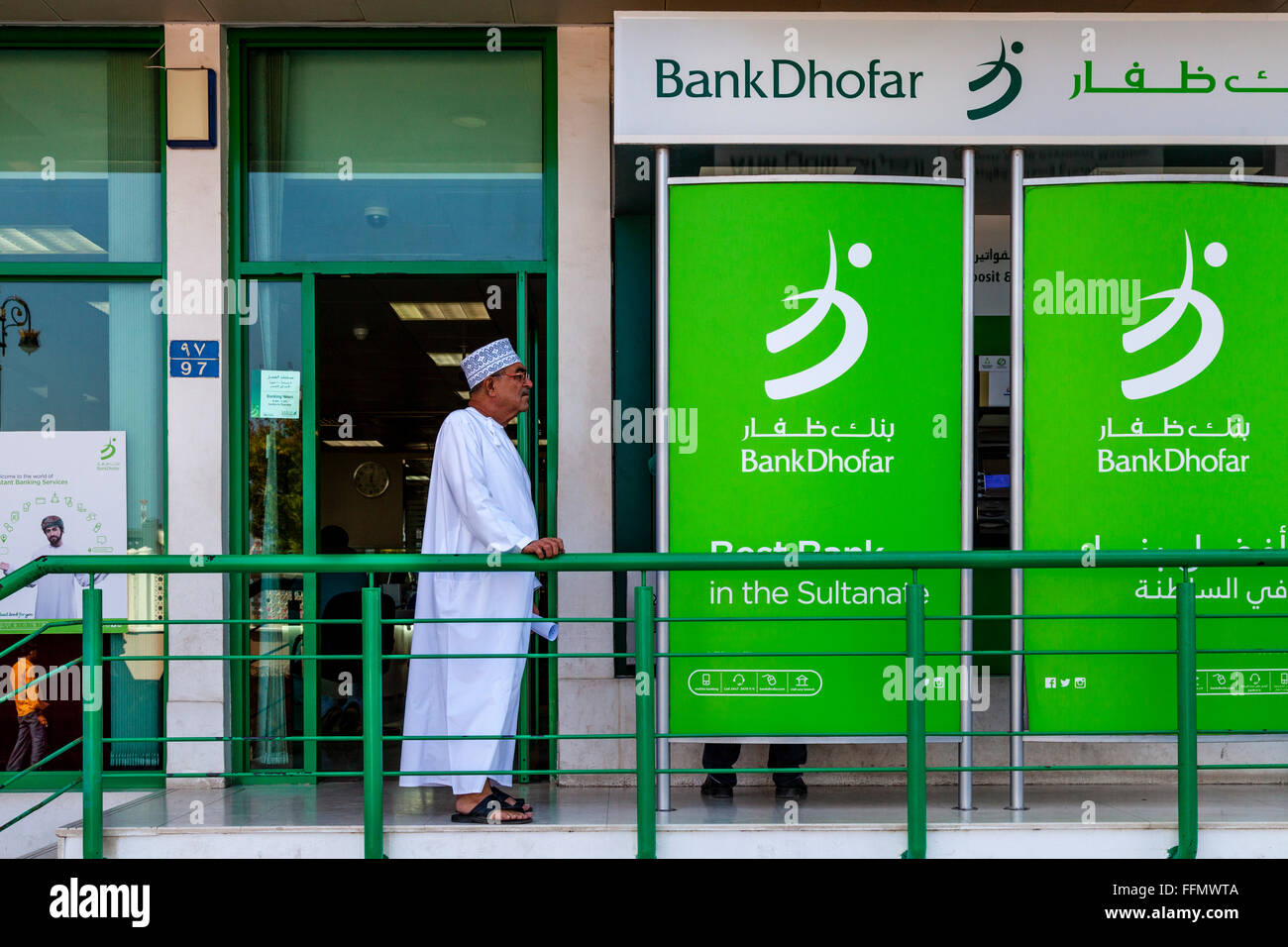 Ein älterer omanischen Mann verlassen einer Bank, Muscat, Sultanat von Oman Stockfoto