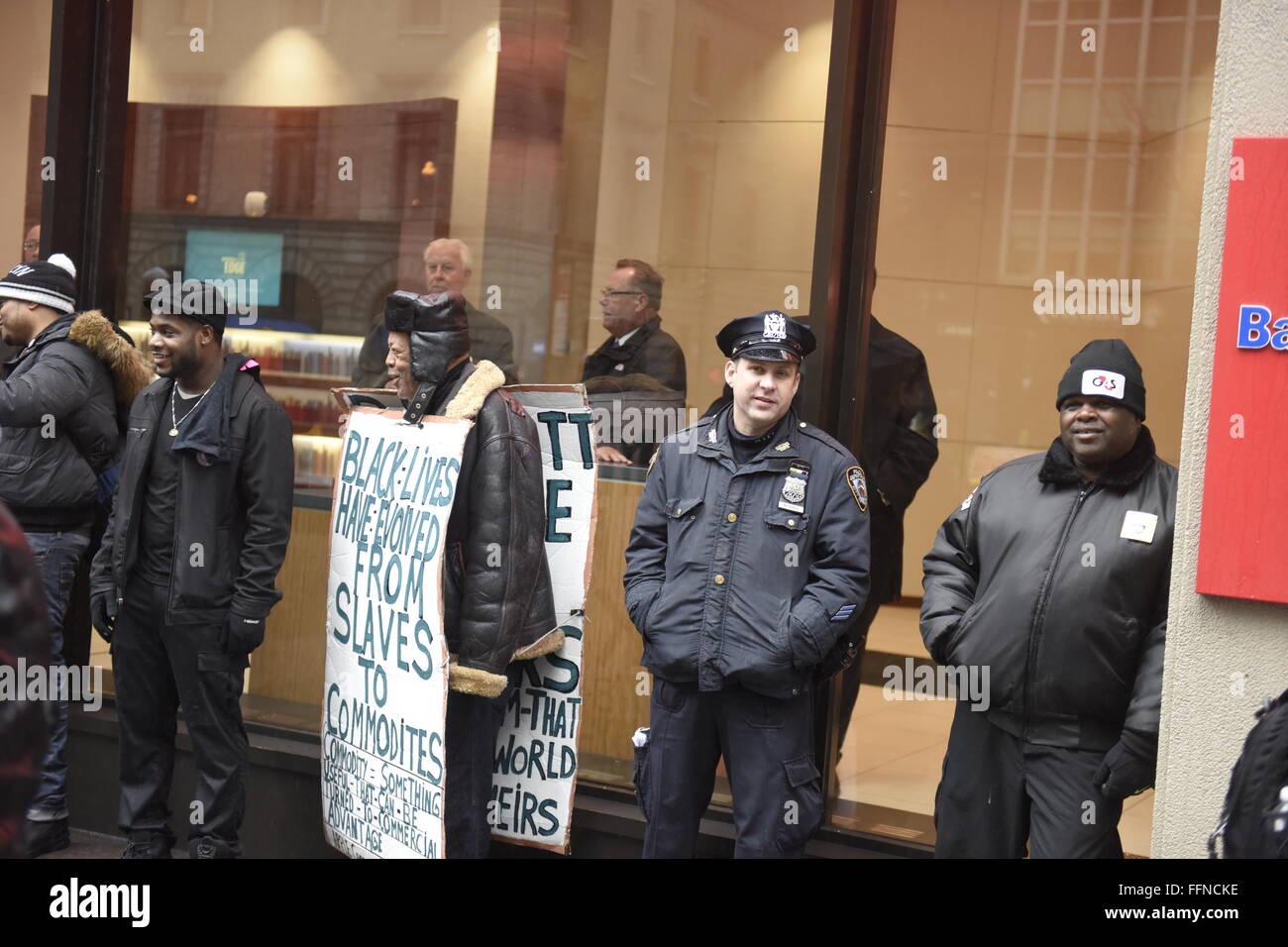 New York, Vereinigte Staaten von Amerika. 16. Februar 2016. NYPD, Aktivisten und drücken Sie suchen Schutz vor dem Regen vor dem Hauptquartier der NFL, Midtown. Mehrere Dutzend Fans von Black lebt Materie, Patriarchat zu stoppen, aufhören Mass Inhaftierung Network und Beyonce Knowles sammelten sich vor dem NFL-Hauptquartier in Midtown Manhattan gegen eine geplante Anti-Beyonce-Demonstration. Bildnachweis: Andy Katz/Pacific Press/Alamy Live-Nachrichten Stockfoto