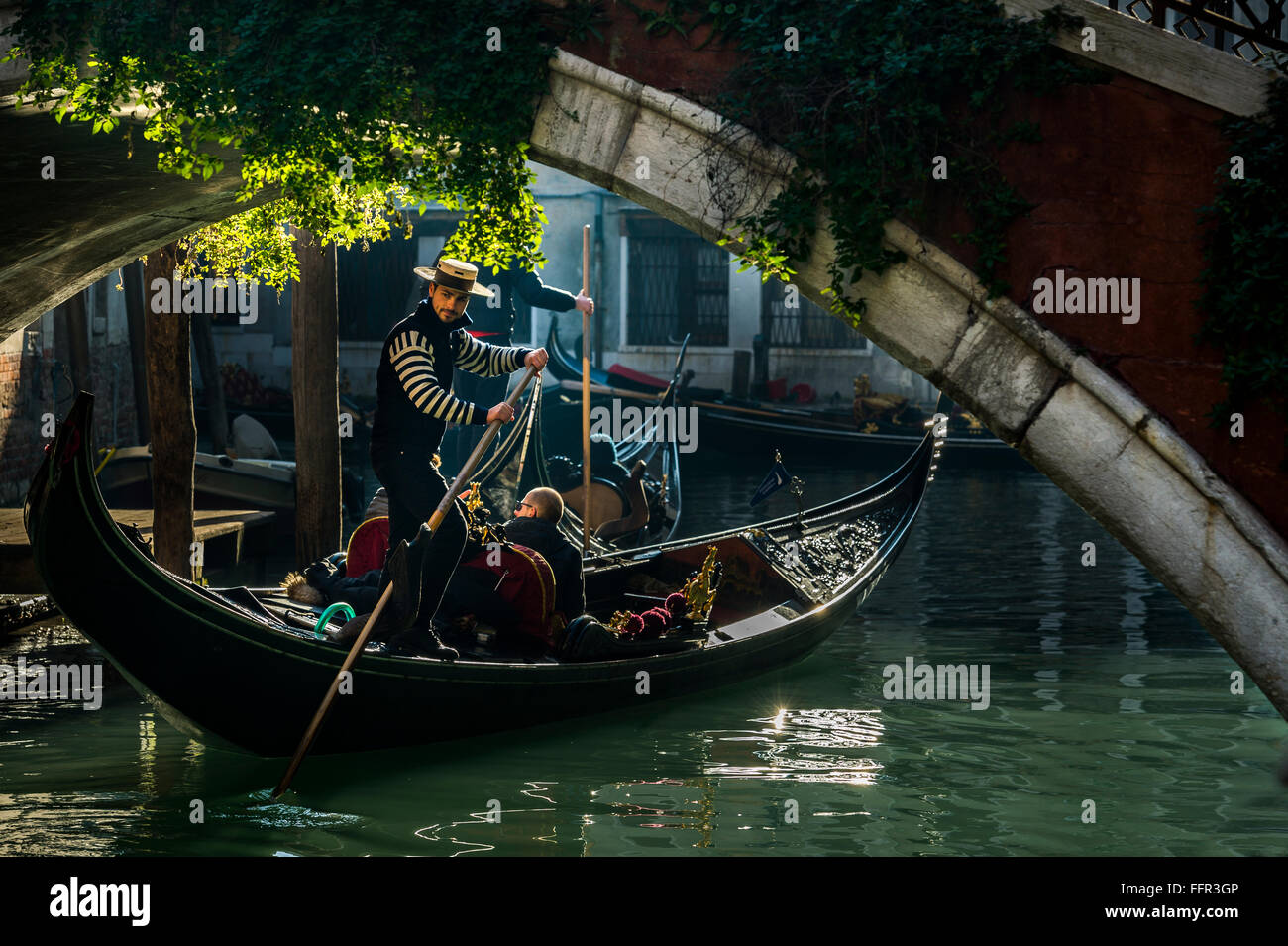Kleinen Kanal reist mit Gondoliere Gondel unter einer Brücke, Venedig, Veneto, Italien Stockfoto