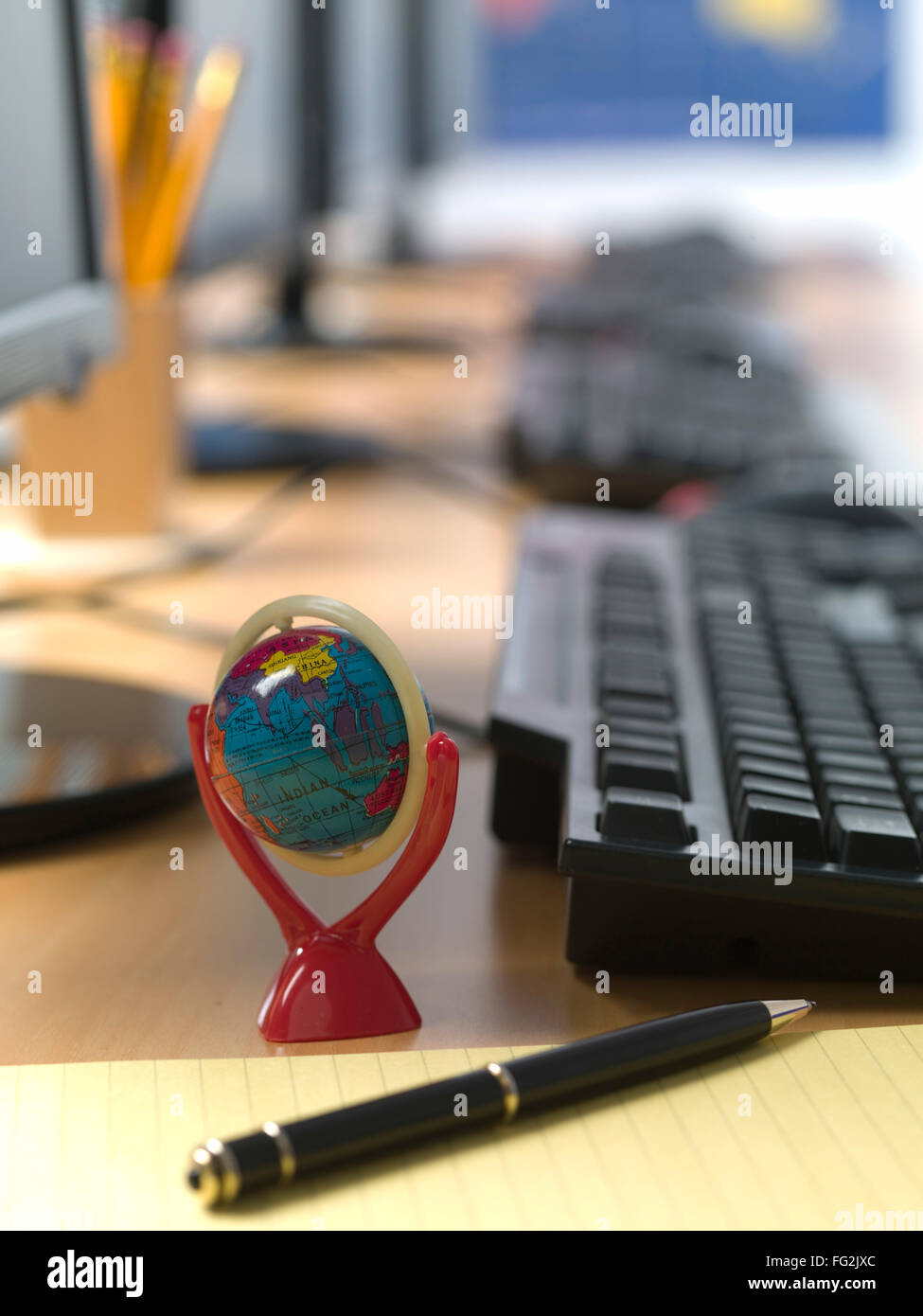 Globus und Stift auf dem Schreibtisch im Büro Stockfoto