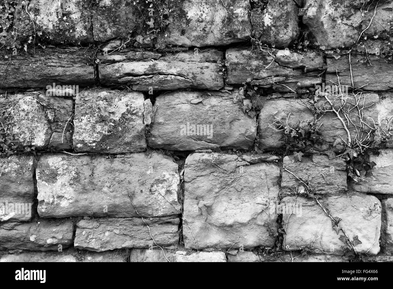 Eine alte, verwitterte, Alter, Stein, Ziegel, sieht Felswand mit Textur und Muster Hintergrund wie ein Gemälde für Wanddekoration geeignet Stockfoto