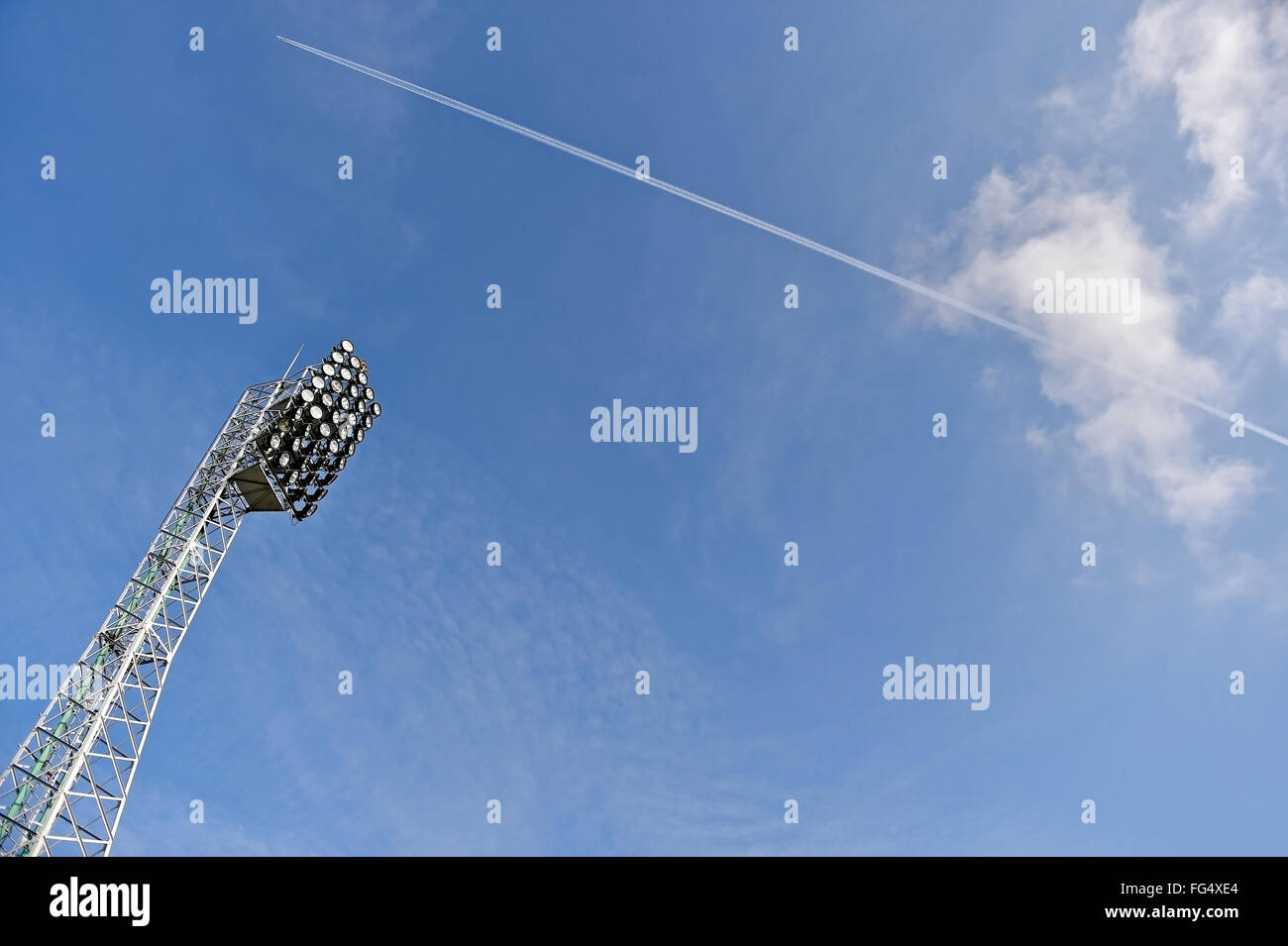 Stadion-Strahler mit Flugzeug über blauen Himmel im Hintergrund Stockfoto