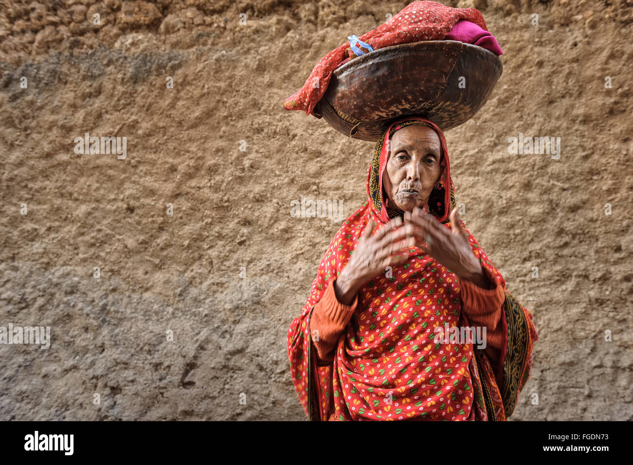 Alten äthiopischen Frau Handlungsinstrumente eine Last auf dem Kopf, die typisch afrikanische Art. Stockfoto