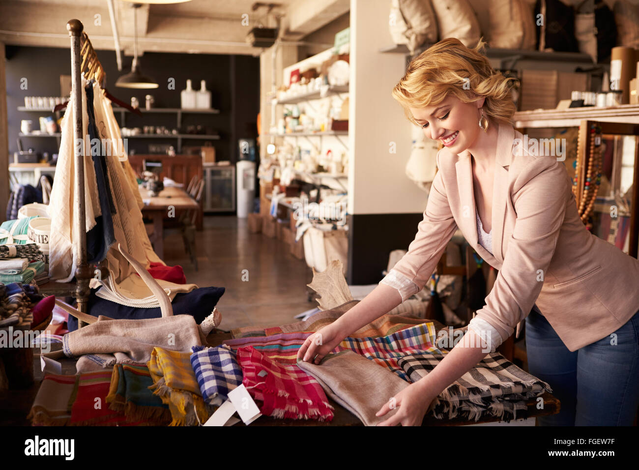 Sales Assistentin Vermittlung von Textilien im Haushaltswaren Shop Stockfoto
