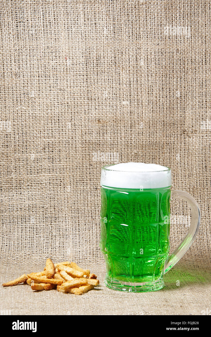 Glas Irish Jungbier und Cracker auf Sackleinen Hintergrund. Traditionelle Symbole der St. Patricks Day. Platz für text Stockfoto