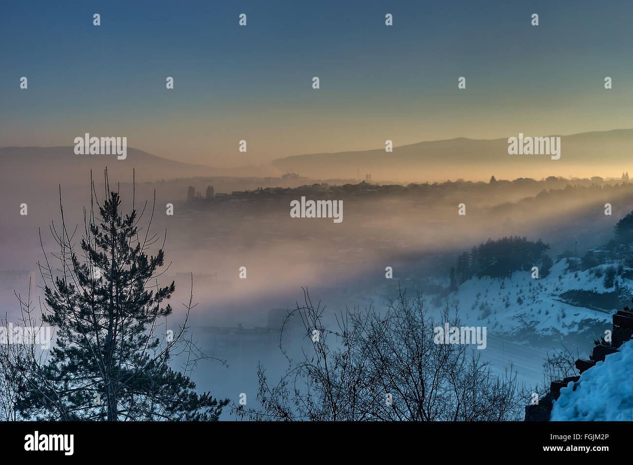 Neblig und farbenfrohen Sonnenaufgang über Stadt Pernik, Bulgarien. Stockfoto