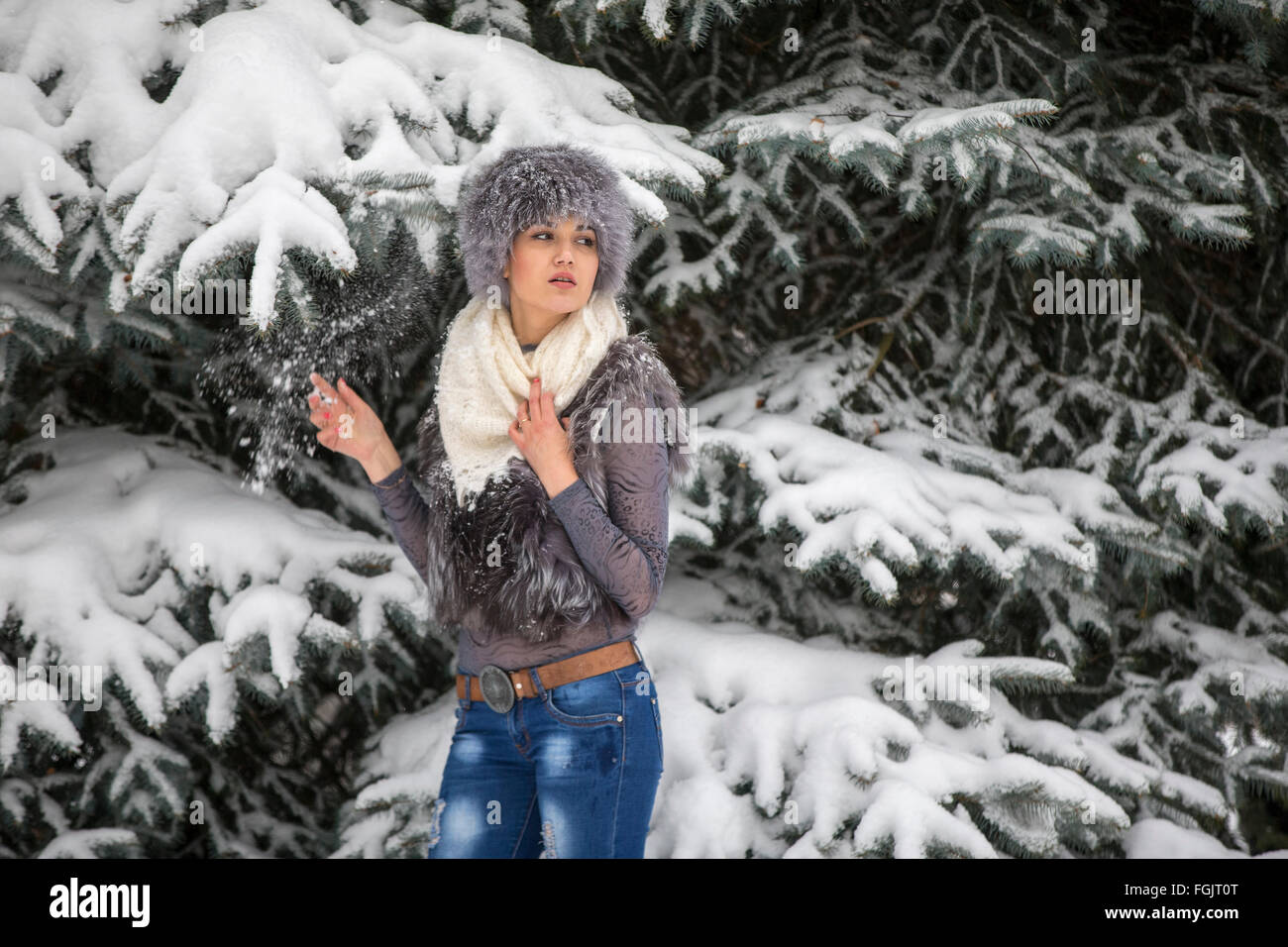 Die Frau in einem eleganten Schal gegen das Holz und Schnee im Winter Weihnachten Stockfoto