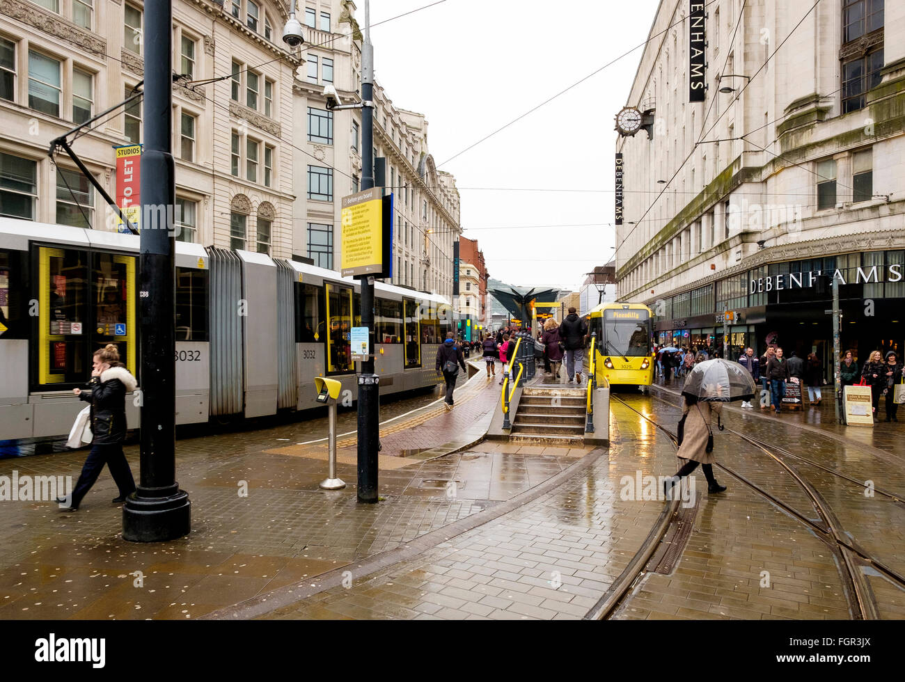 Manchester, UK - 17. Februar 2016: der belebten Marktstraße Straßenbahnhaltestelle an einem regnerischen Wintertag Stockfoto