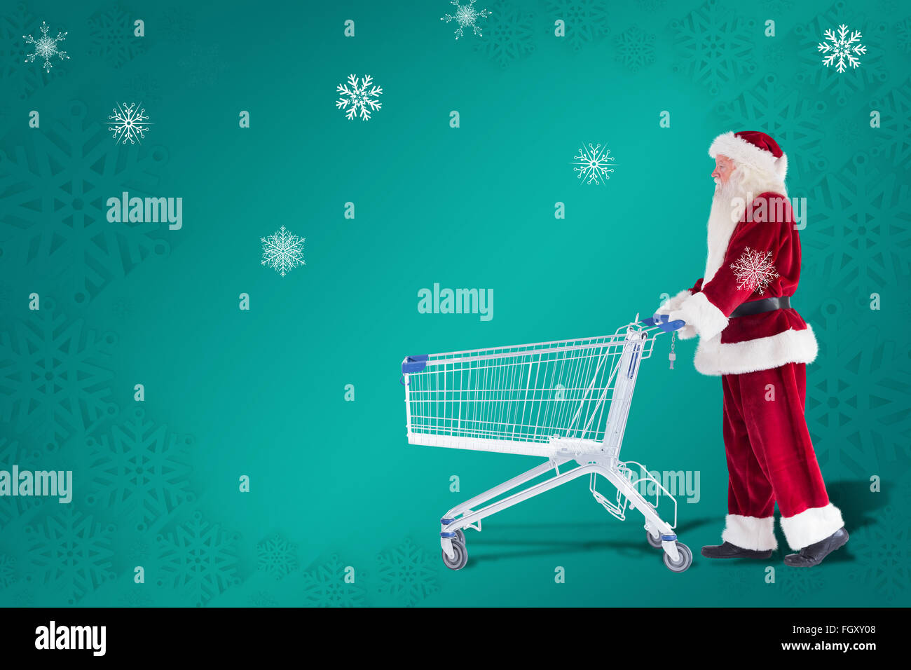 Zusammengesetztes Bild von Santa schiebt einen Einkaufswagen Stockfoto
