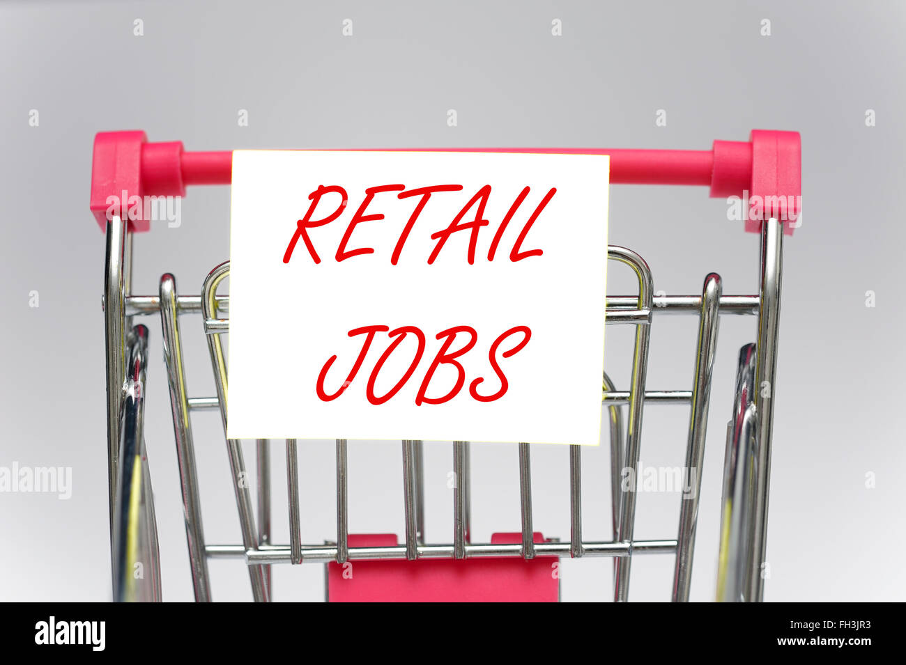 Ein Miniatur-Einkaufswagen mit Einzelhandel Jobs anmelden Stockfoto