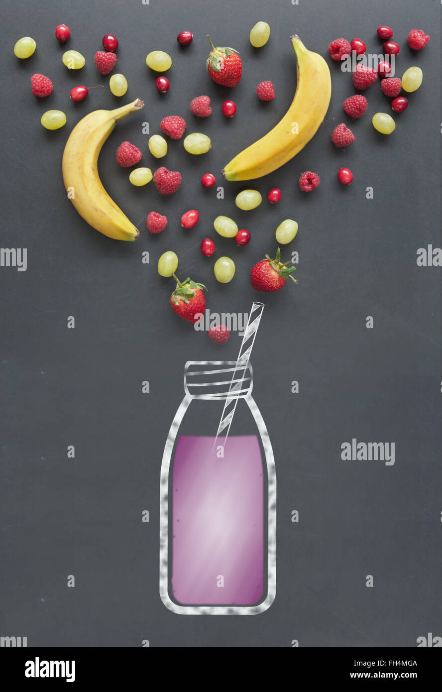 Frisches Obst wie Beeren, Cranberrries und Himbeeren neben einer Zeichnung einen Smoothie auf einer Kreidetafel Stockfoto