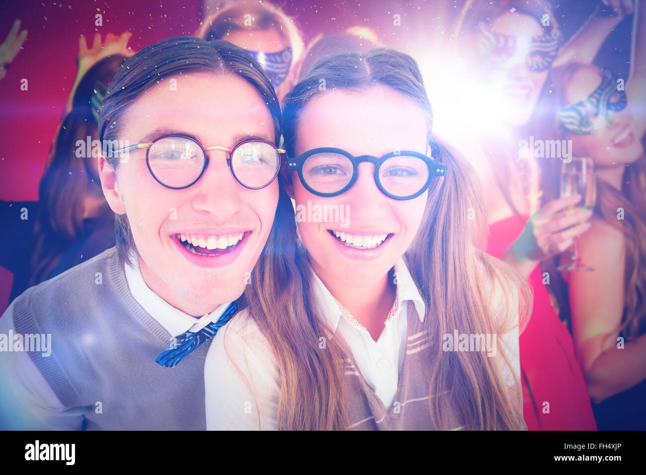 Zusammengesetztes Bild von geeky Hipster lächelnd in die Kamera Stockfoto