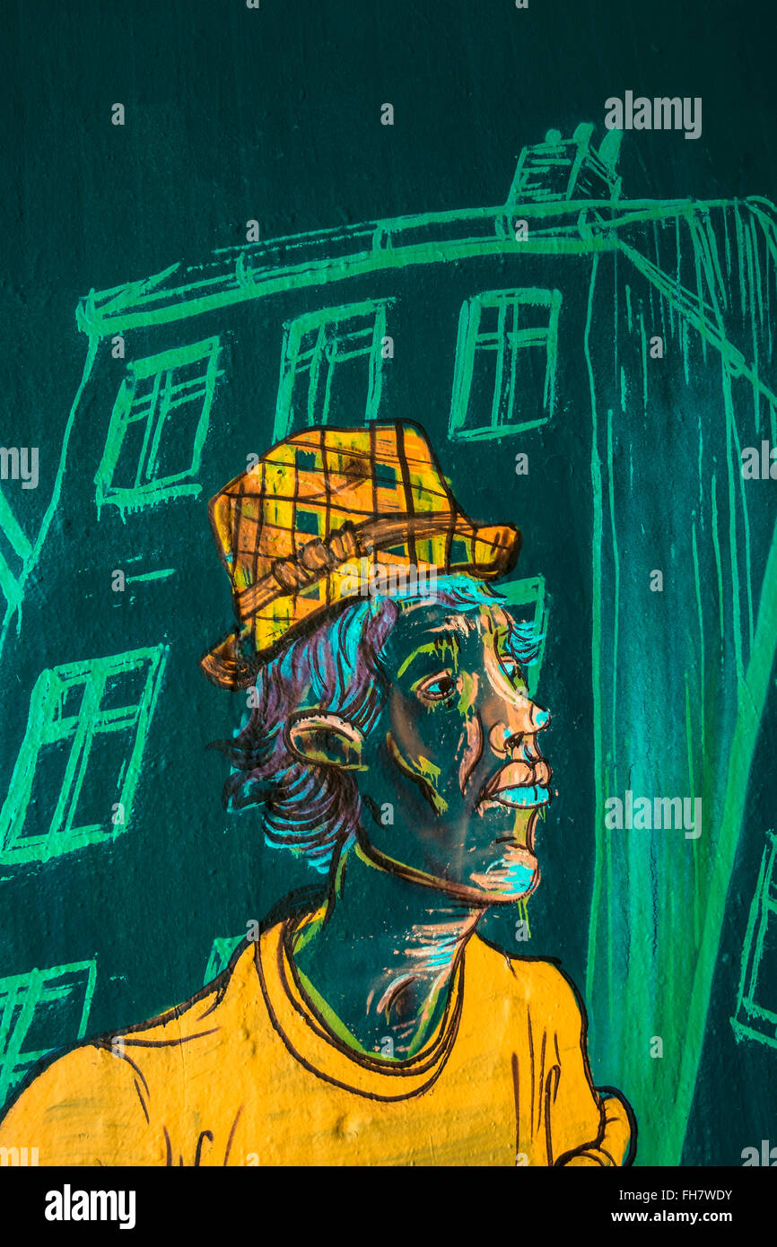 Graffito zeigt einen Mann mit Hut, Haus im Hintergrund Stockfoto
