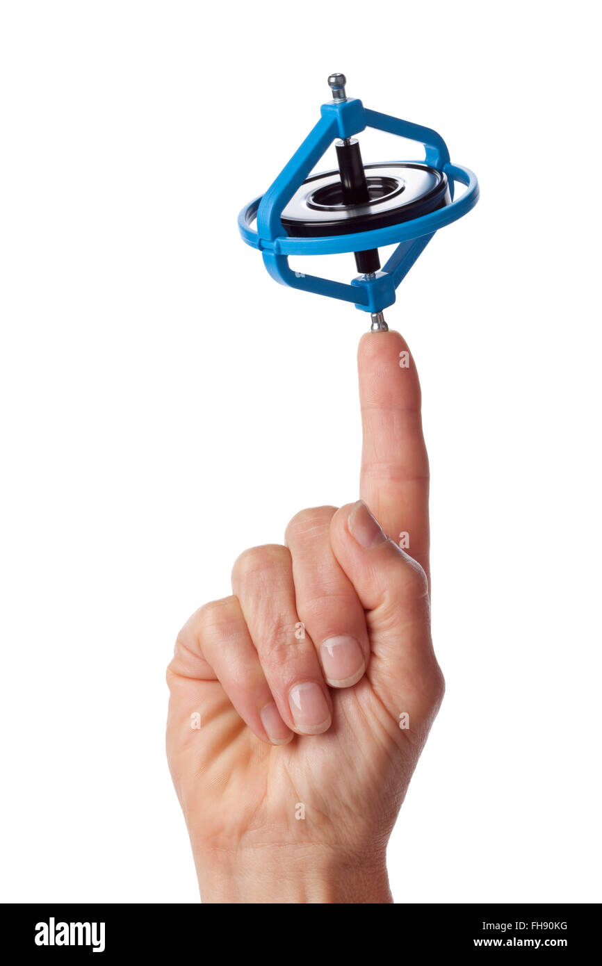 Finger mit einem drehenden Gyroskop auf weißem Hintergrund Stockfoto
