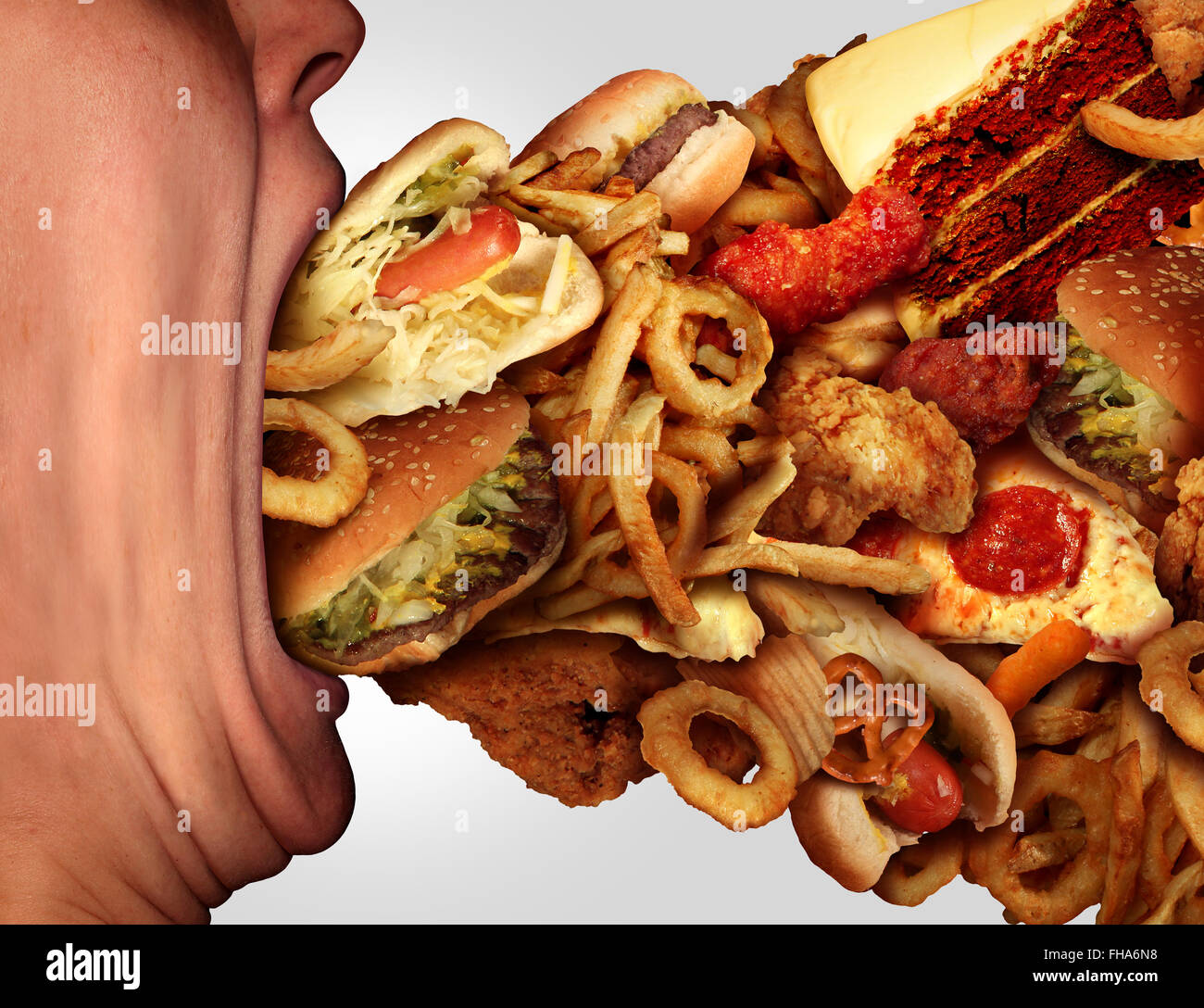 Junk-Food-Ernährung und Diät Gesundheit Problem Konzept als eine Person mit einem großen Mund weit offen Schlemmen auf einen übermäßig großen Gruppe von ungesunden Fast Food und Snacks zu essen. Stockfoto