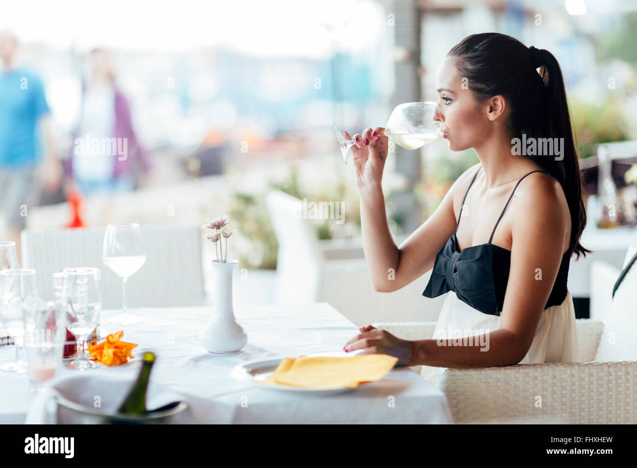 Frau weiß Weinproben im Restaurant und Glas entsprechend anheben Stockfoto