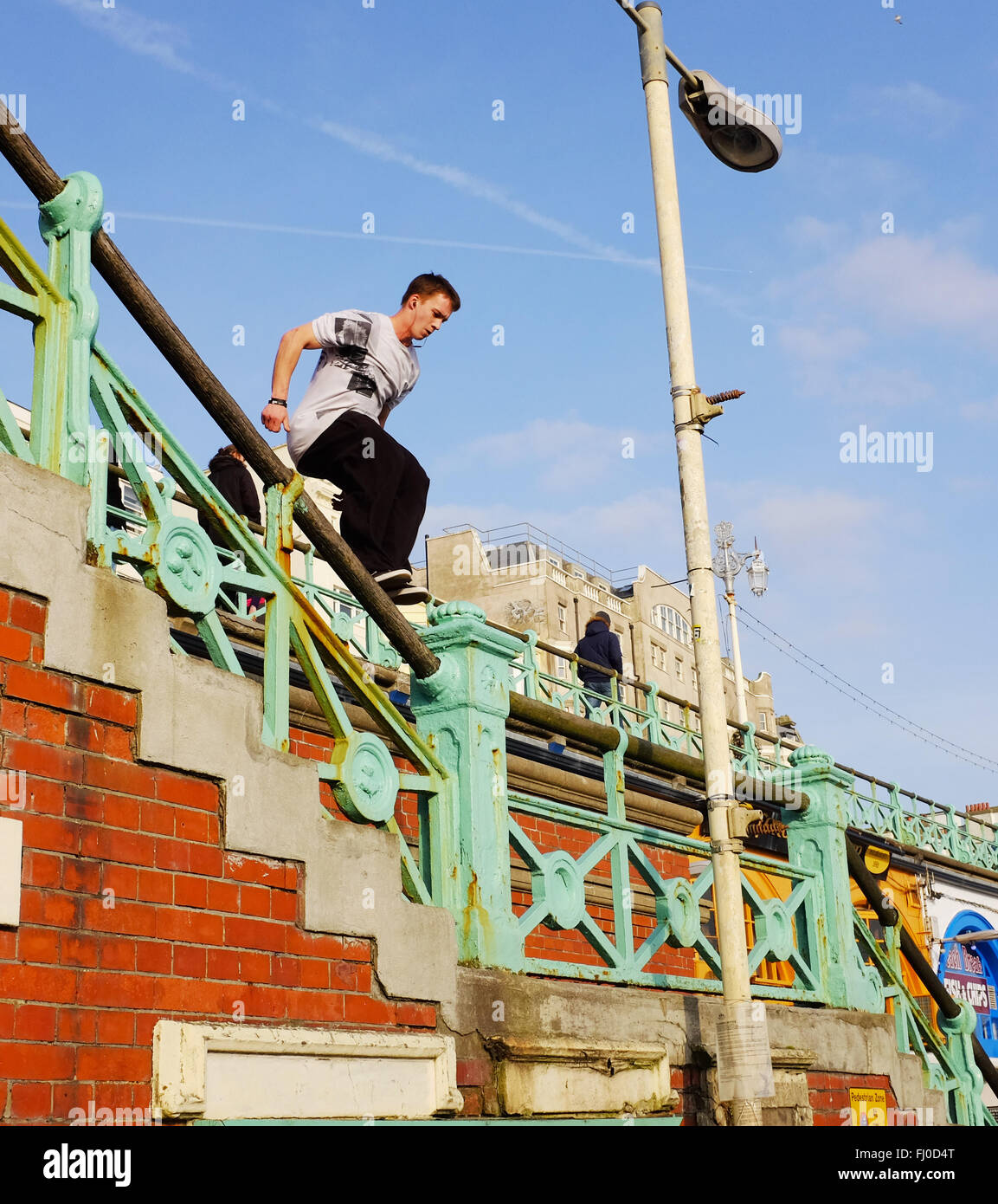 Ein Junge männliche freie Läufer springt über Brighton Seafront UK Stockfoto