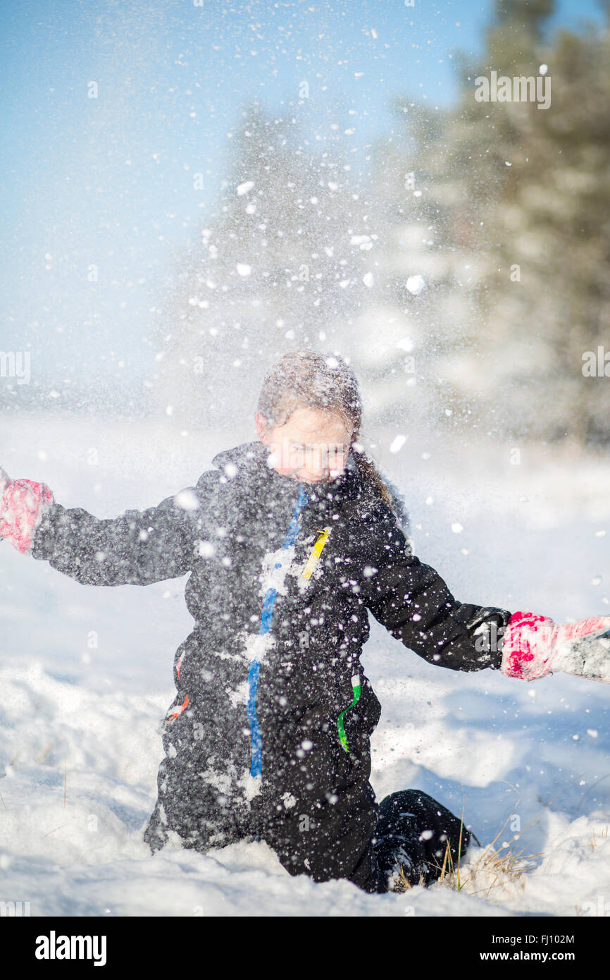Mädchen werfen Schnee in der Luft Stockfoto