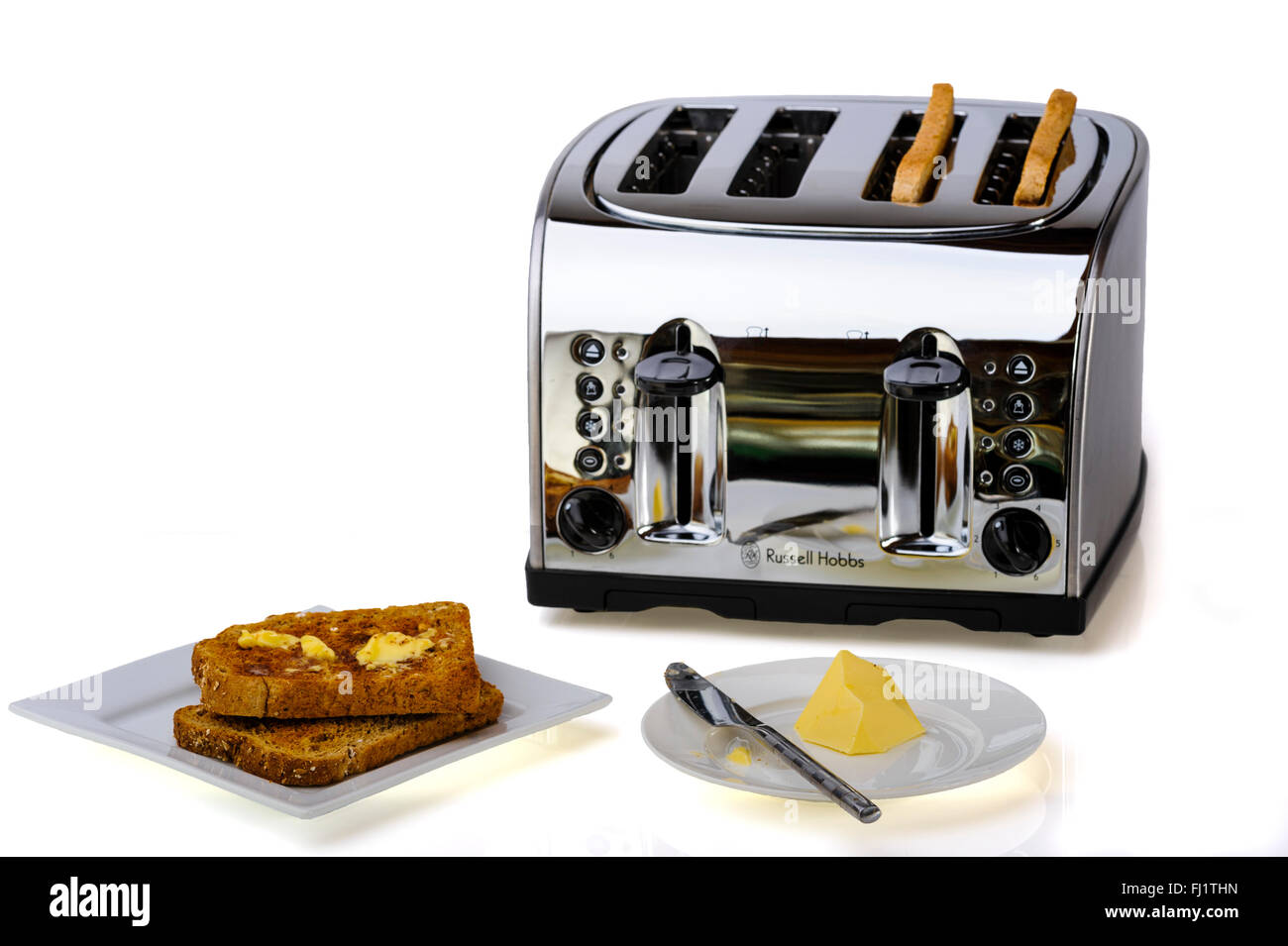 Vier Stück, chrom Toaster mit Toast und Butter. Stockfoto