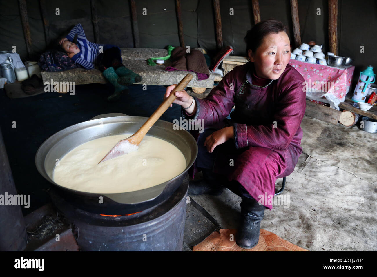 Tsaatan Frau vorbereiten Milch für den Käse, Menschen, die mit Rentier in Zentralasien Stockfoto