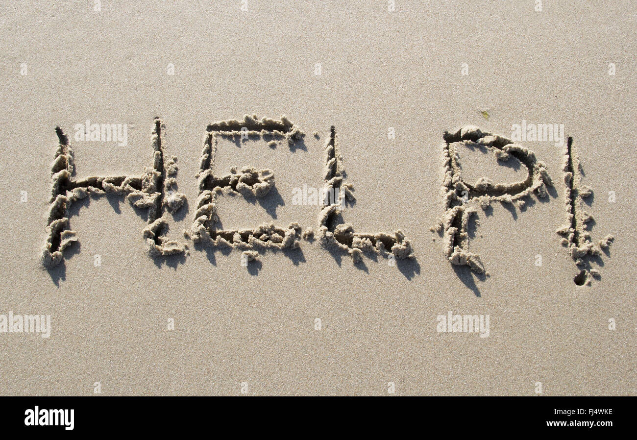 Hilfe geschrieben am Sandstrand Stockfoto