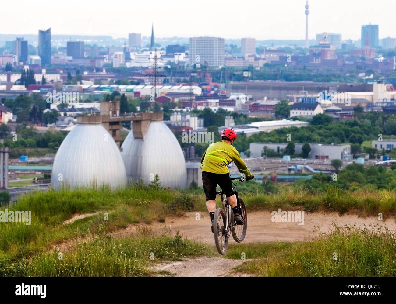 Mountainbiker auf ehemaligen Abfallentsorgung, die Skyline von Dortmund im Hintergrund, Dortmund, Ruhrgebiet, Nordrhein-Westfalen, Deutschland Stockfoto