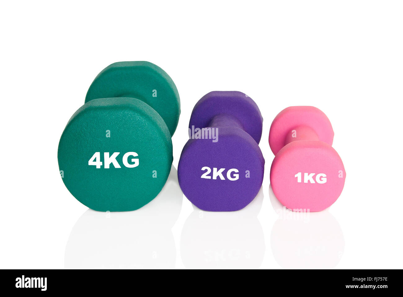 Rosa, grün und lila Hanteln isoliert auf weißem Hintergrund. Gewichte für ein Fitness-Training. Stockfoto