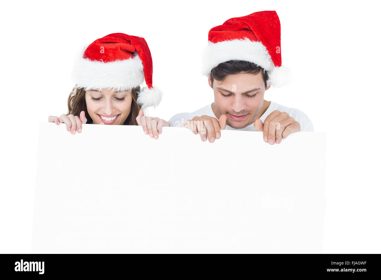 Brautpaar mit Weihnachtsmütze hält ein Plakat Stockfoto