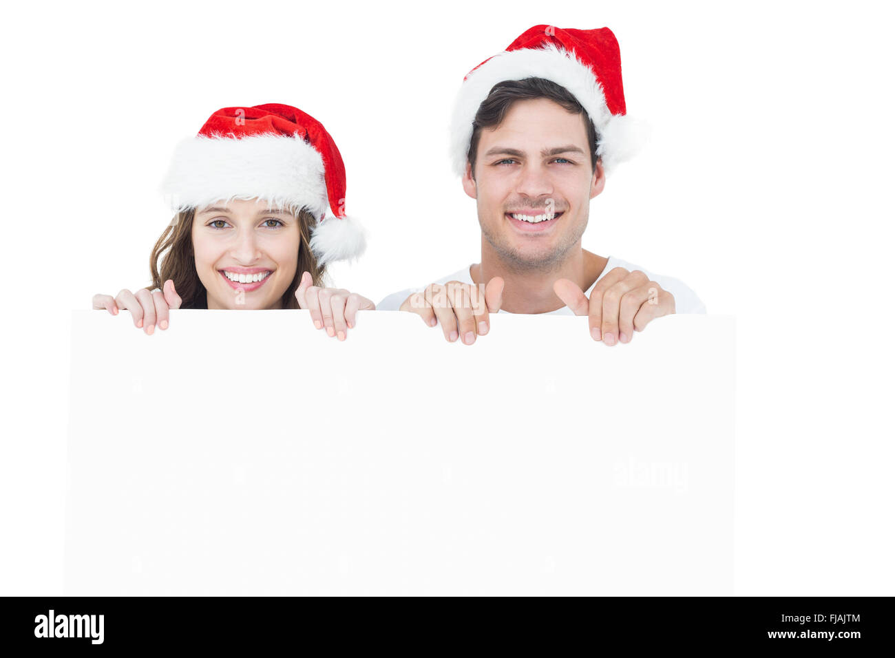 Brautpaar mit Weihnachtsmütze hält ein Plakat Stockfoto
