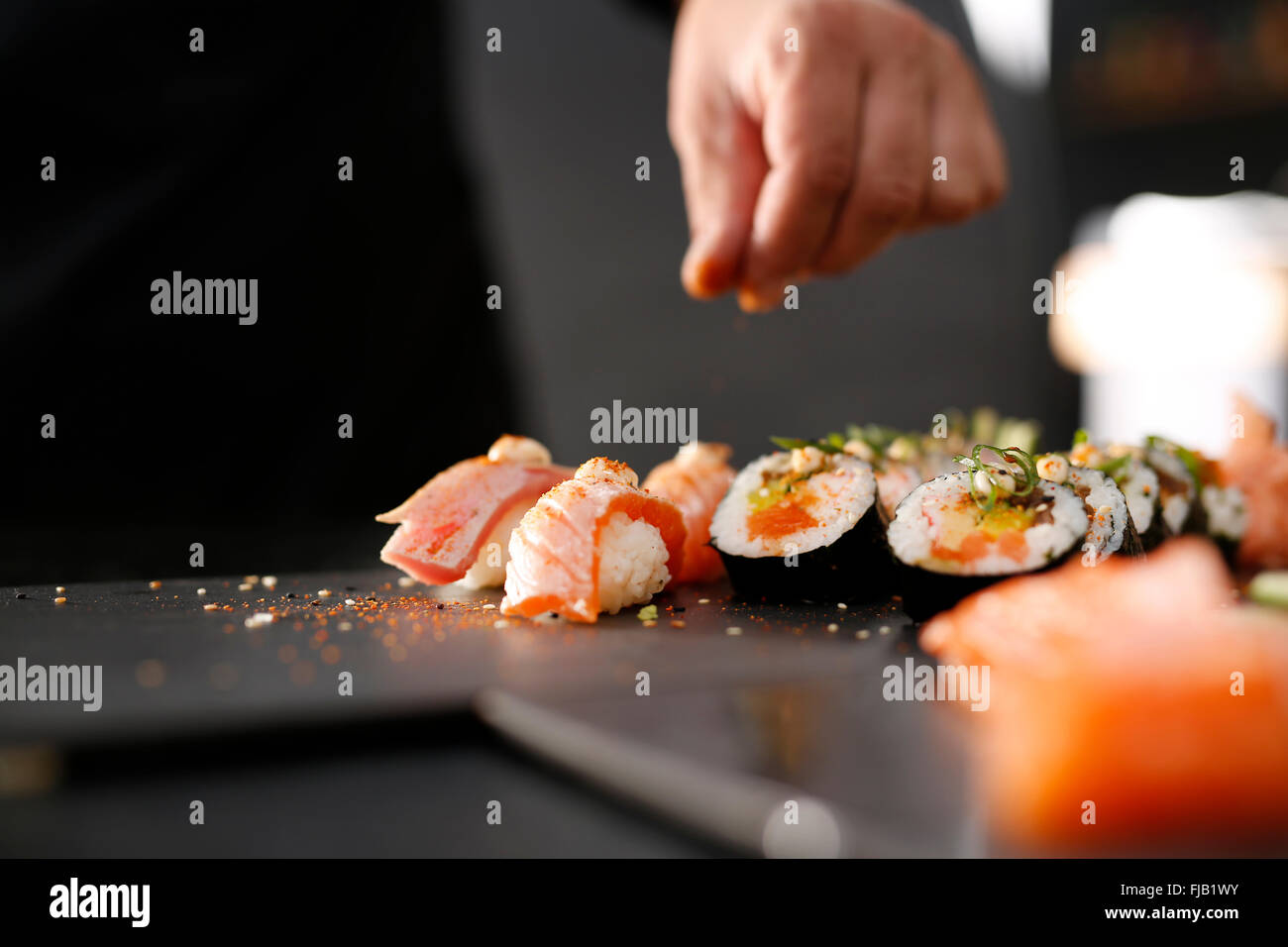 Bildung von Sushi. Die Schritte zum Erstellen von Sushi mit rohen Lachs. Zubereitung von Sushi im japanischen Restaurant Sushi-Meister. Stockfoto