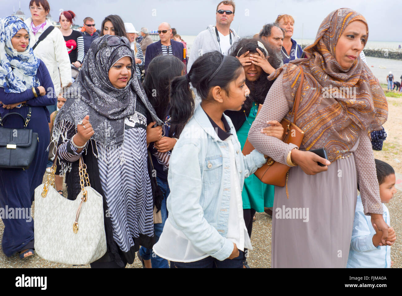 Eine Gruppe von Menschen im mittleren Osten ein Spaziergang entlang der Strandpromenade Stockfoto