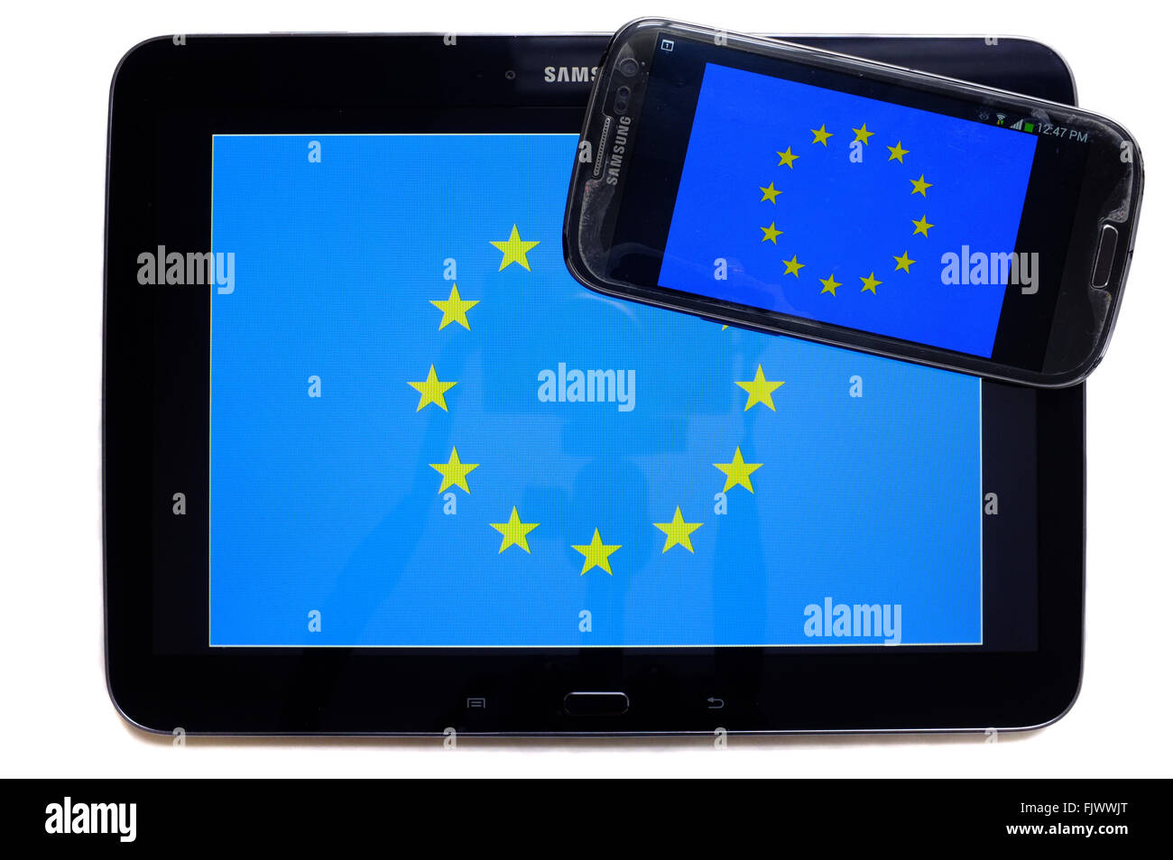 Die Flagge der EU auf einem Tablet-Bildschirm mit der EU-Flagge auf einem Smartphone fotografiert vor einem weißen Hintergrund angezeigt. Stockfoto