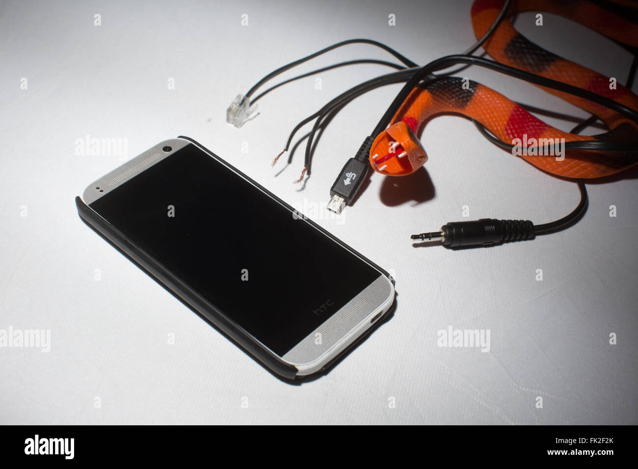 Ein Handy und eine Auswahl an falsche Ladegerät Kabel Stockfoto