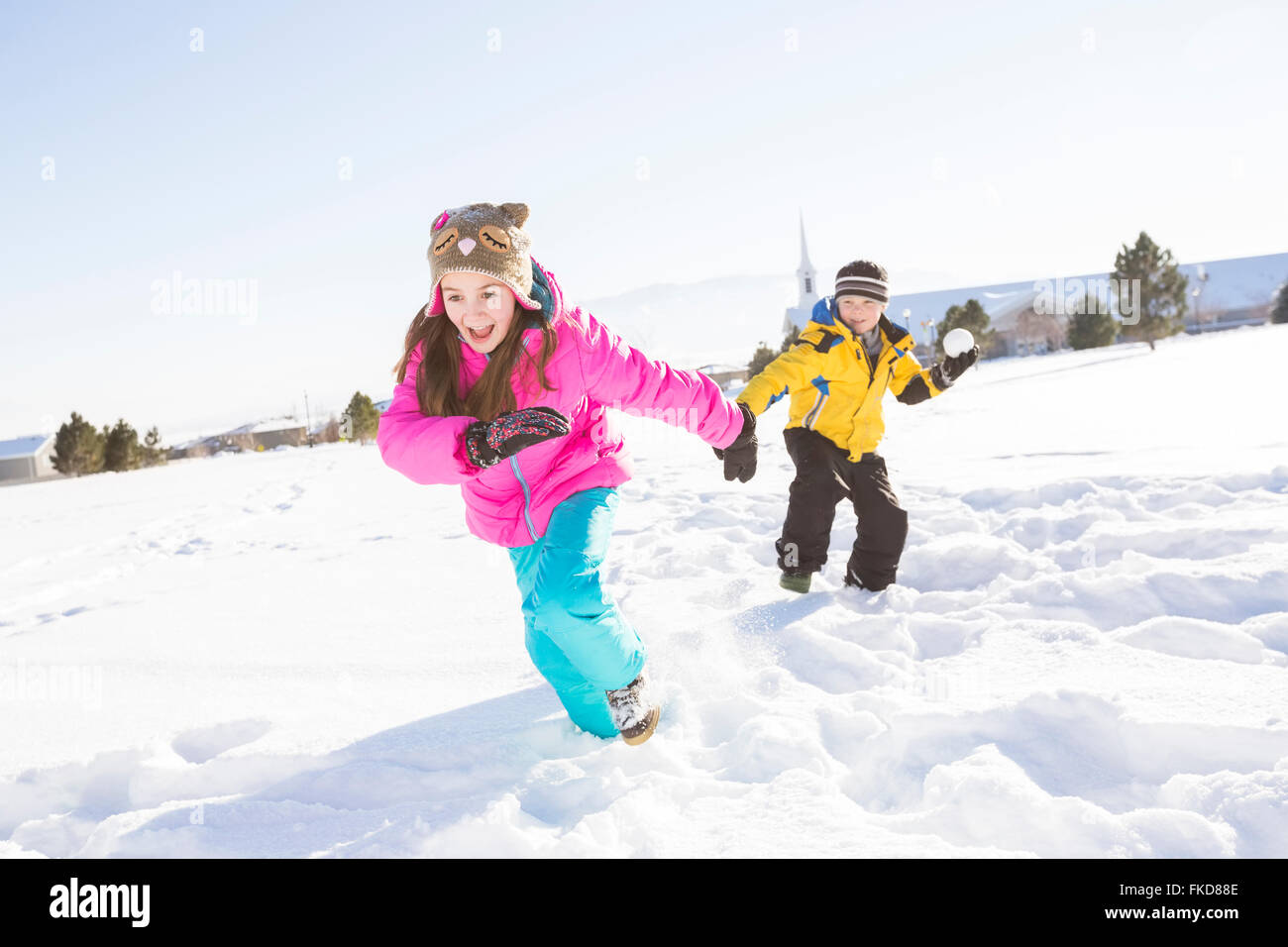 Kinder (8-9, 10-11) spielen im Schnee Stockfoto