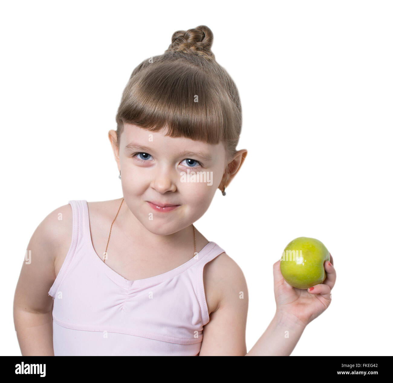 kleine Ballerina mit einem Apfel in einem rosa Kleid Stockfoto