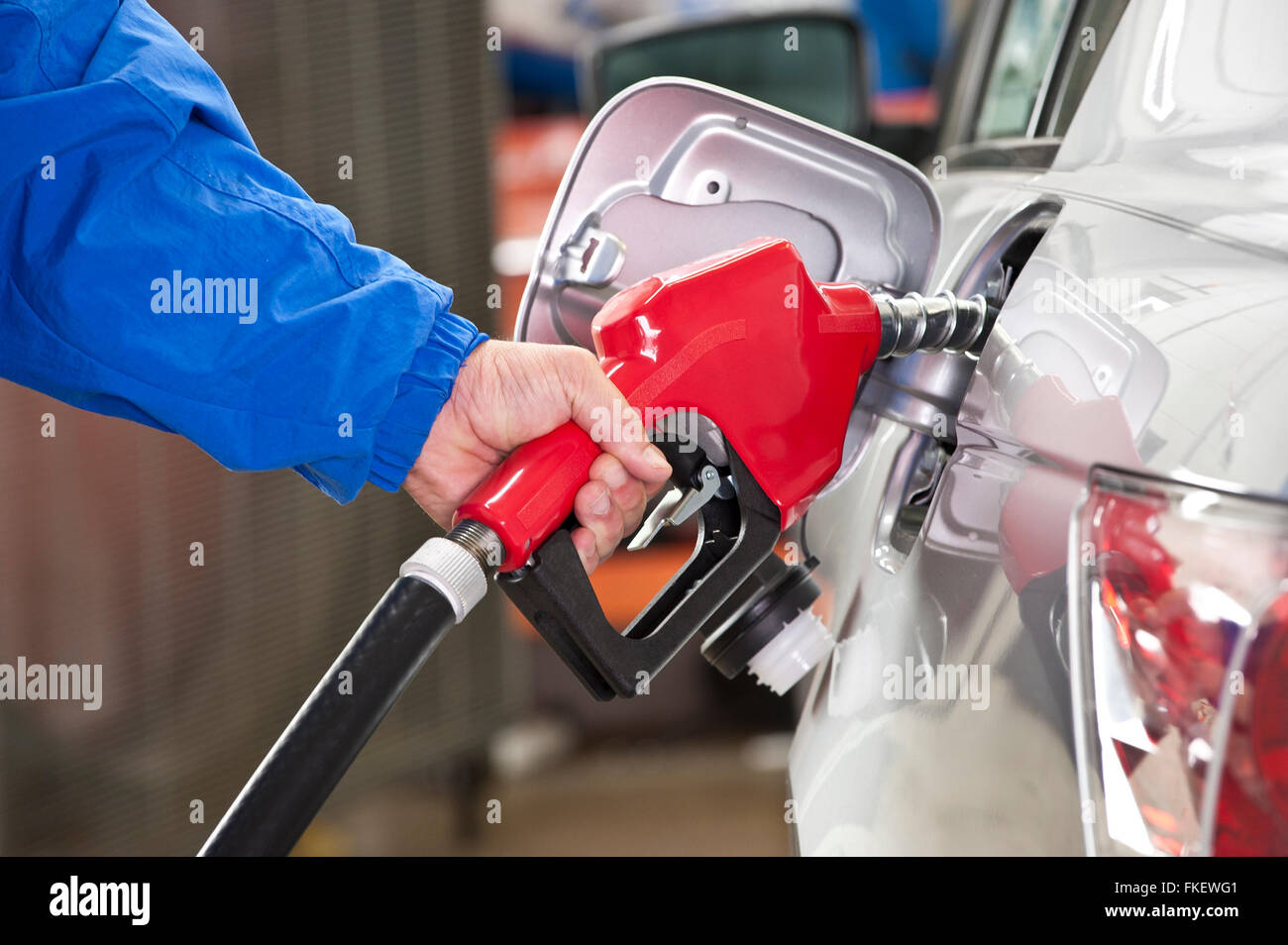 Frau in Silber Auto mit roten Brennstoff Düse Benzin Pumpen Stockfoto