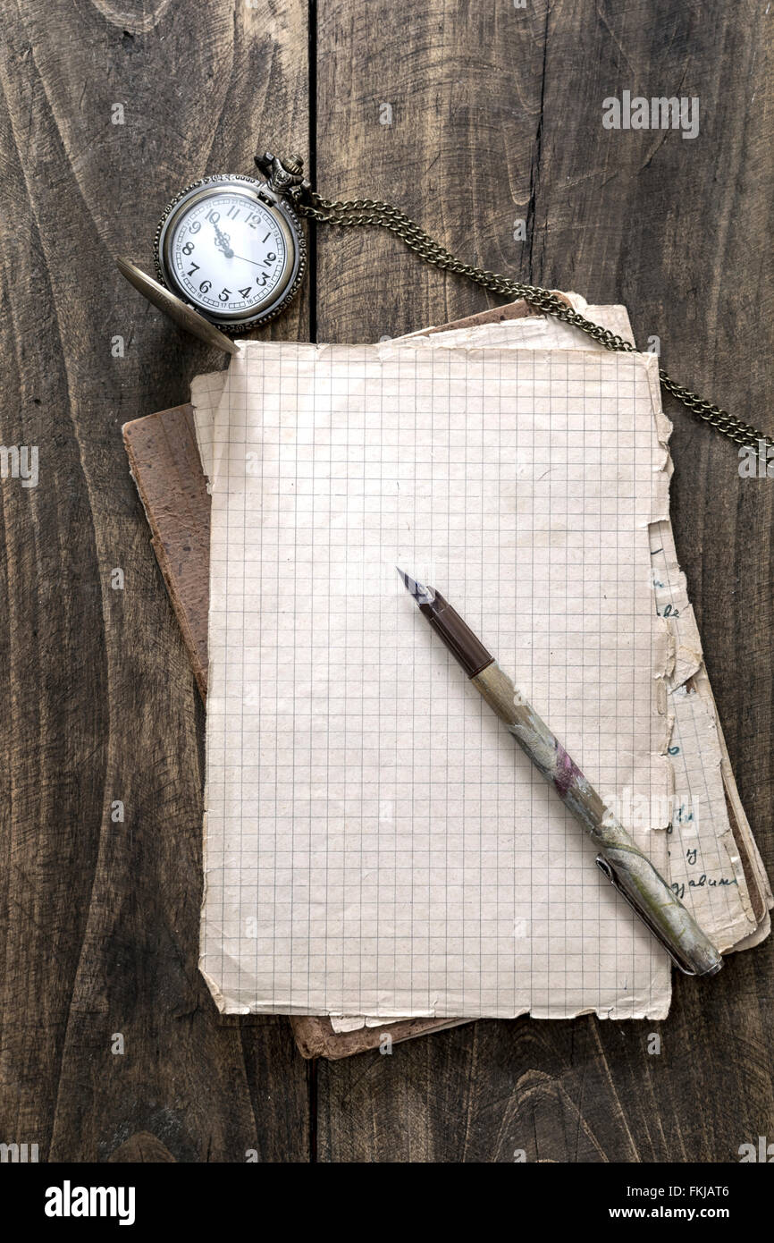 Antikes Buch und alte Taschenuhr auf hölzernen Hintergrund Stockfoto