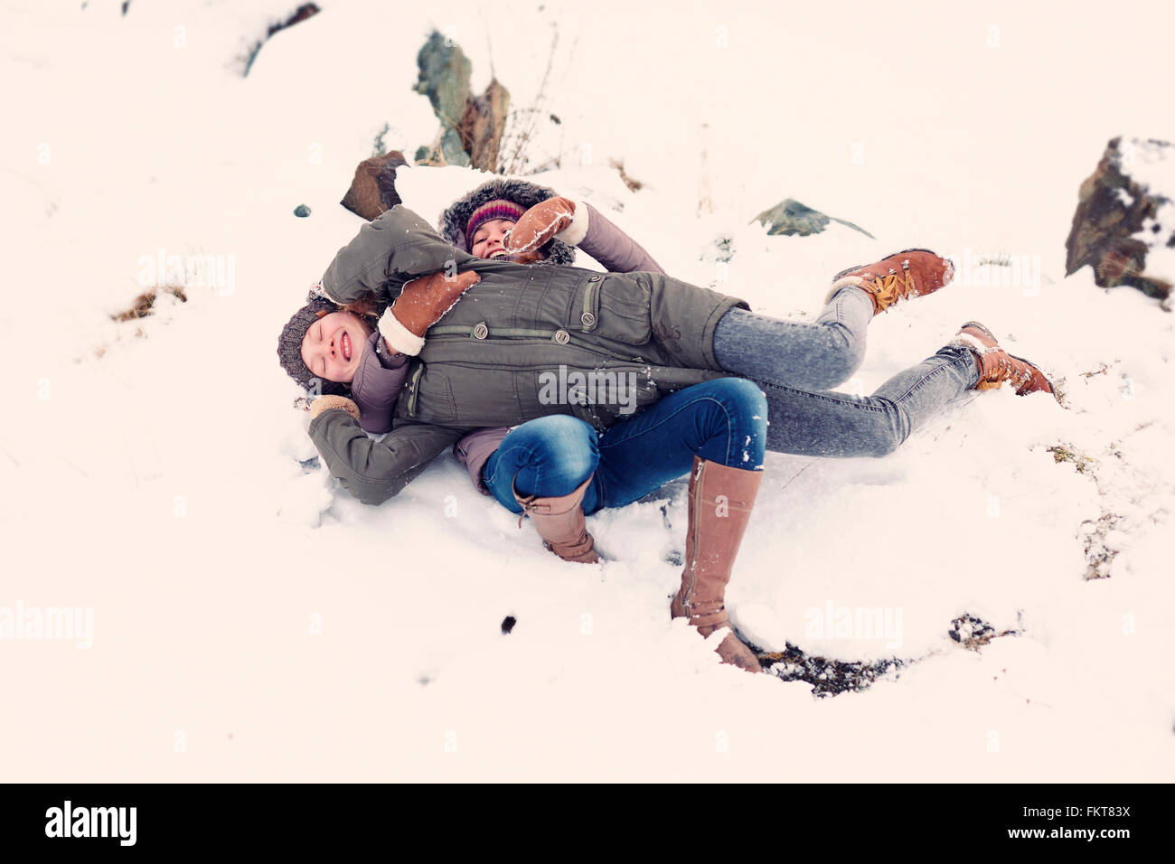 Kaukasische Mädchen im Teenageralter spielen im Schnee Stockfoto